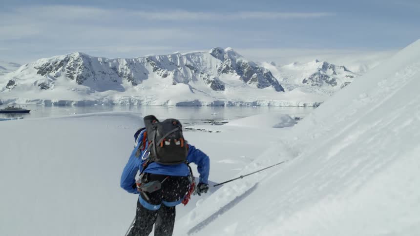 A skier makes his way down a steep slope