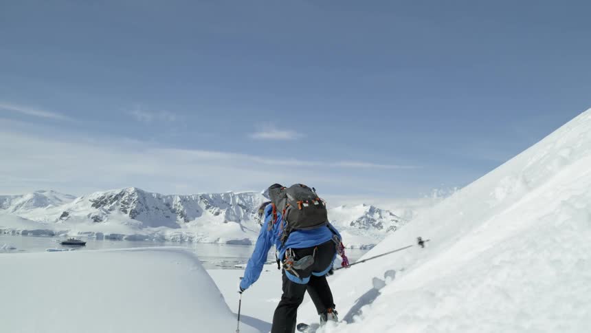 A skier makes his way down a steep slope