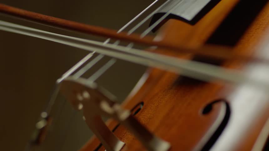 Bow drags over cello strings