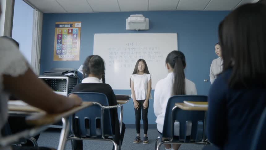 A child is giving a presentation in class