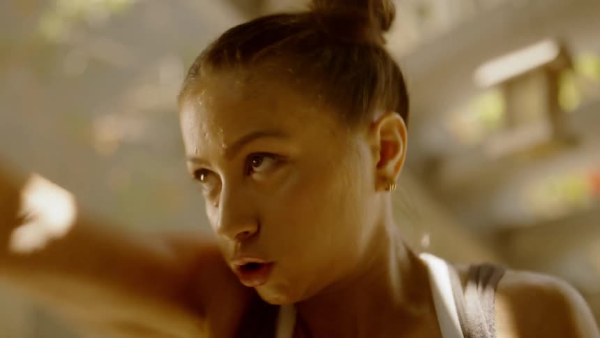 A woman boxes and punches the air