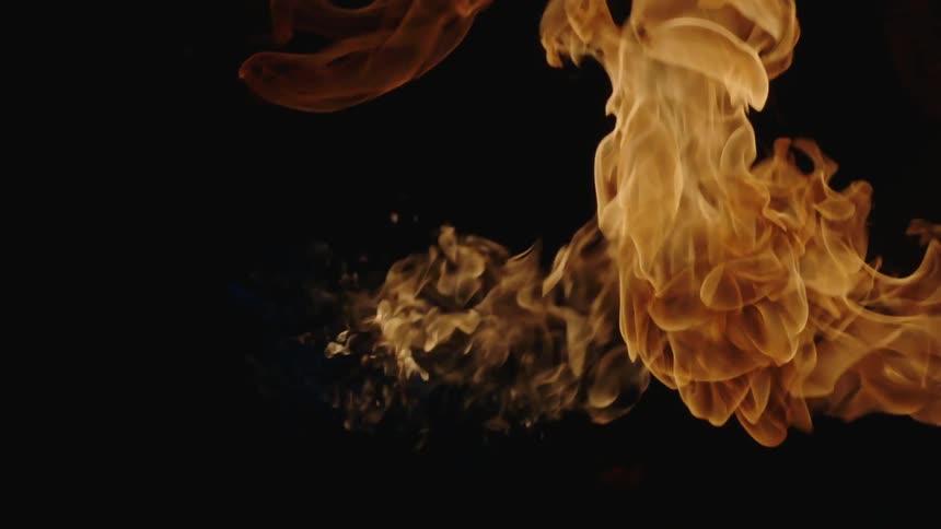 A flame ignites in a dark area