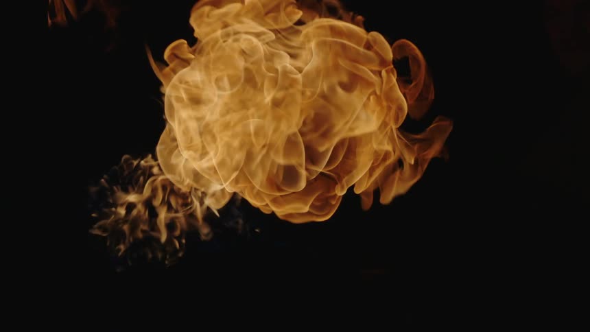 A flame bursts and burns out on a black background