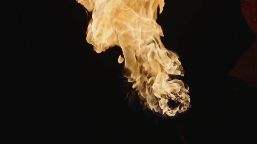 A torch bursts into flames and billows out