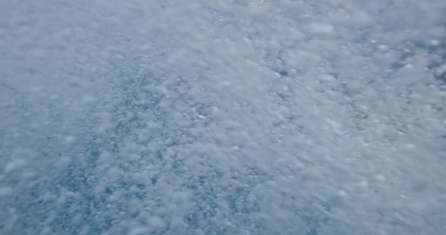 Water splashing all over the camera as it submerges in water to film sharks
