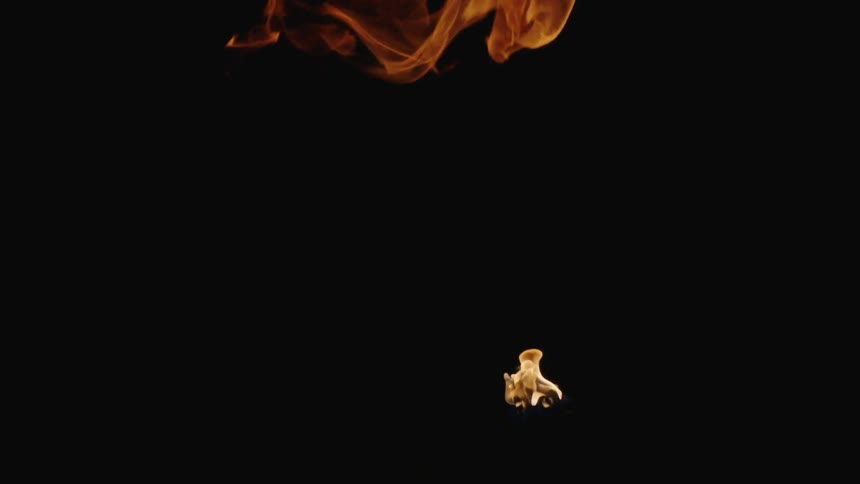 Ball of fire rising against a black background