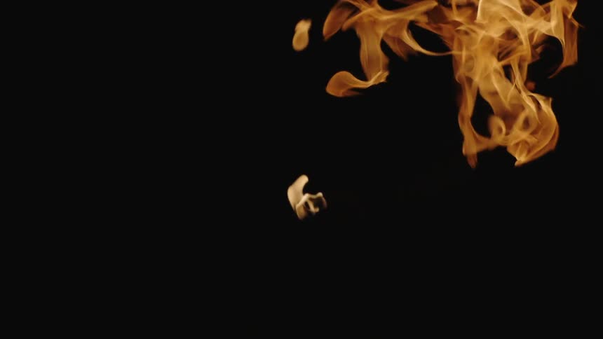 A hand holds a flaming torch