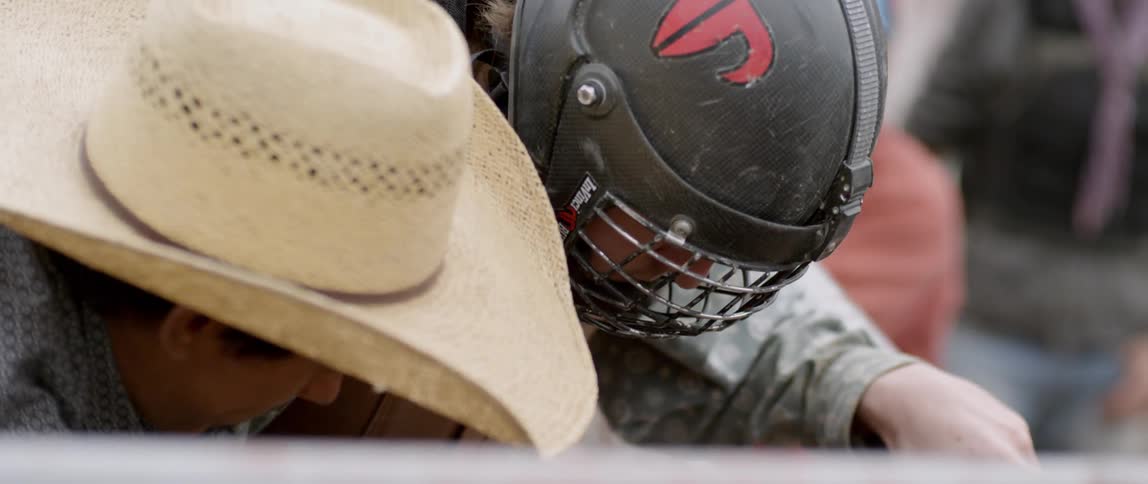 A cowboy prepares to ride a bull