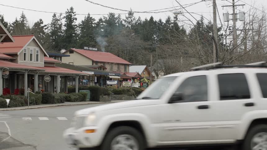 Cars driving down the street in a small town