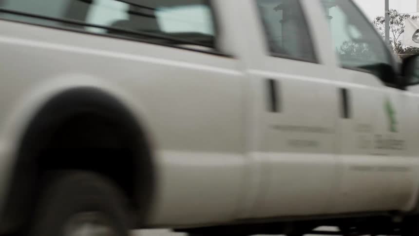 The white truck makes the turn past the intersection