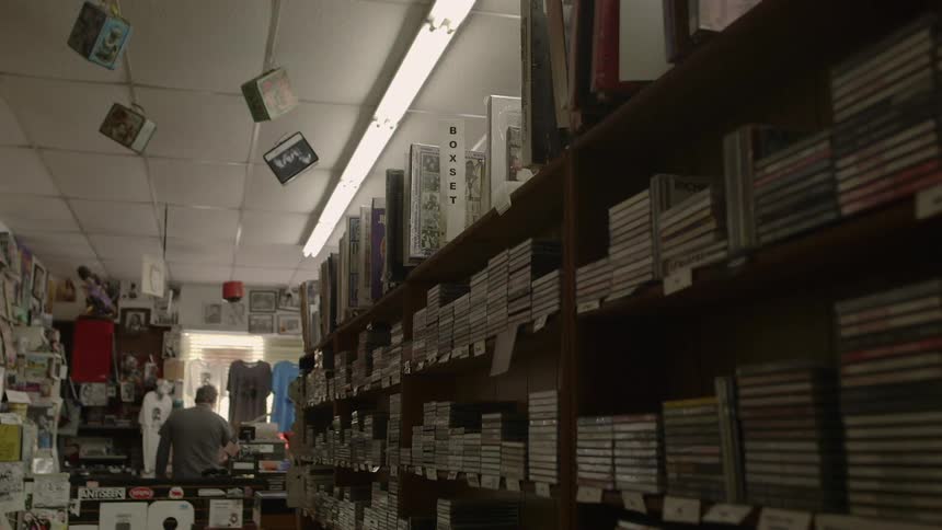 A man is working in a shop during the day