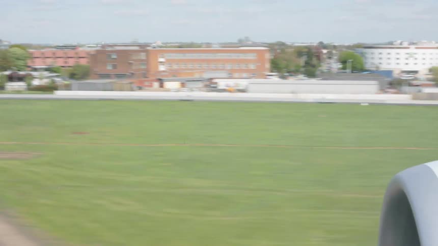 City and a field rolls by