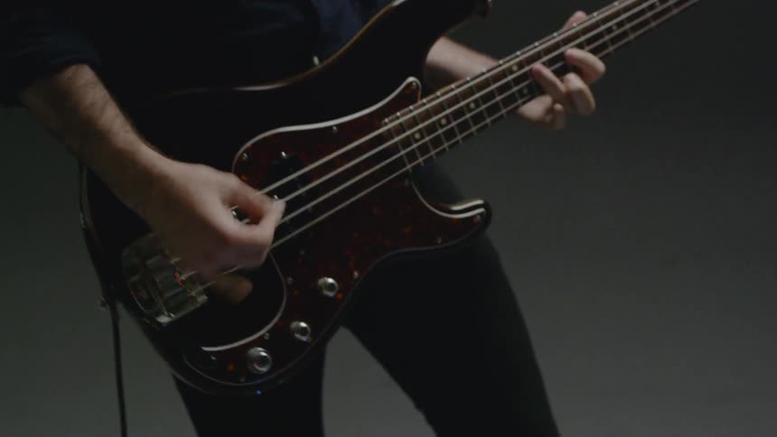 A man plays a bass guitar