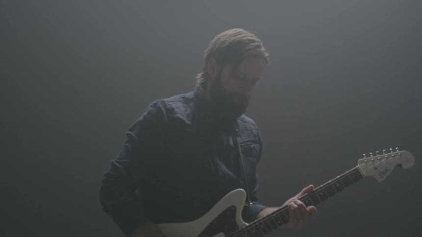 A man plays a guitar
