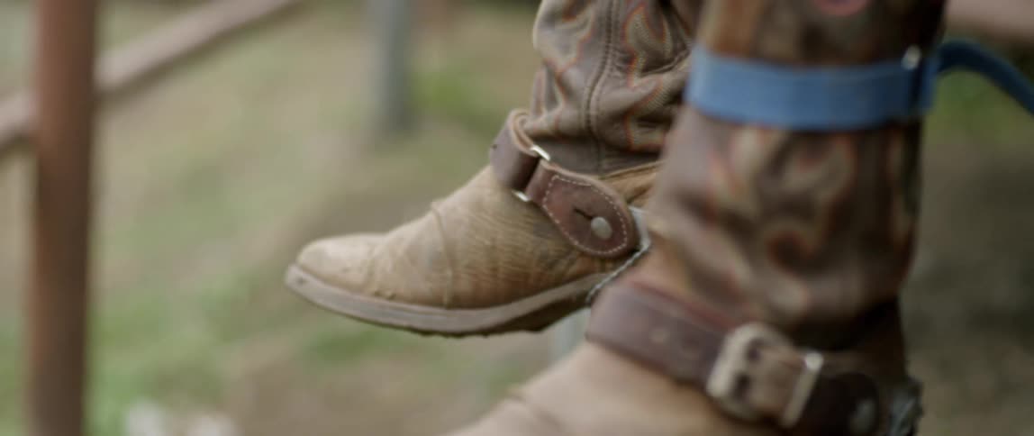 Cowboy boots swing back and forth