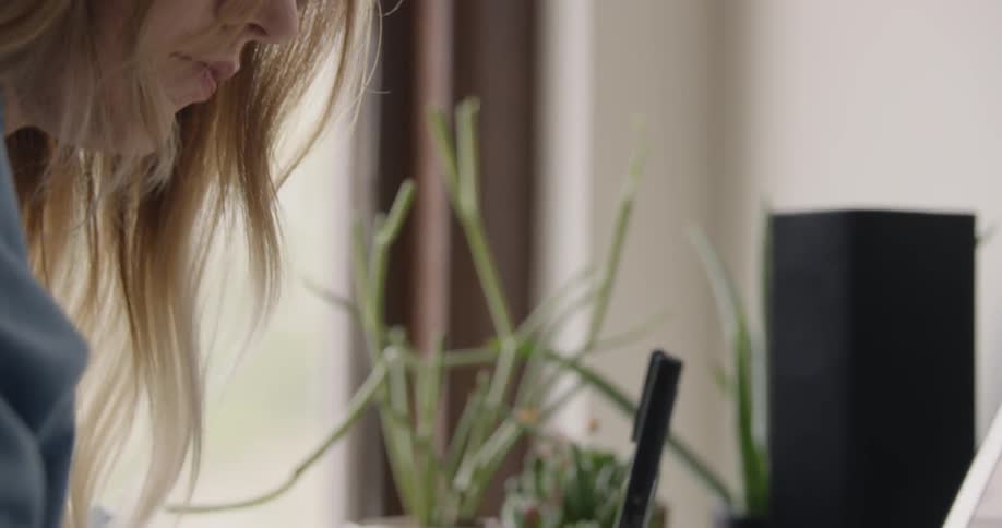 Female College Student writes at a desk
