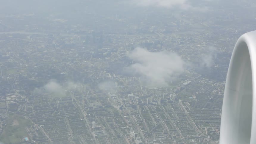 A jet flies over a city