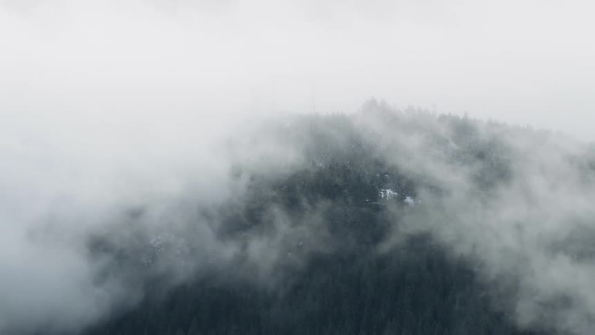 Fog and and haze hang off the top of a mountain