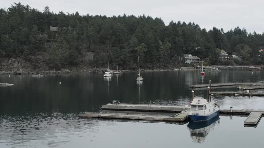 Small boats on a calm lake on a cloudy day