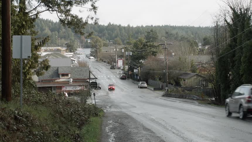 Vehicles travel down a town road