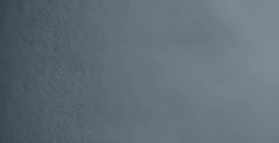 Fog rolls up against a white surface