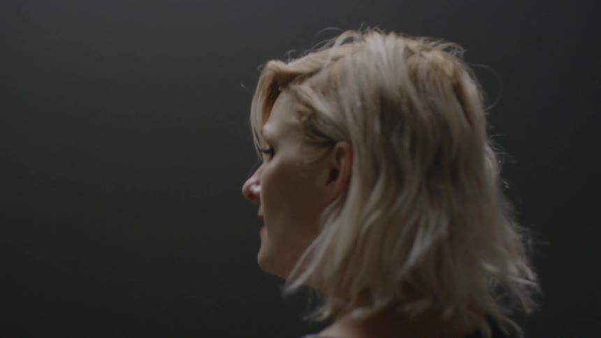 A woman sings to herself