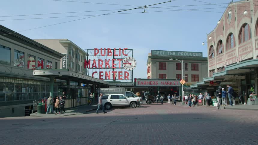 People milling around a market area on a clear day