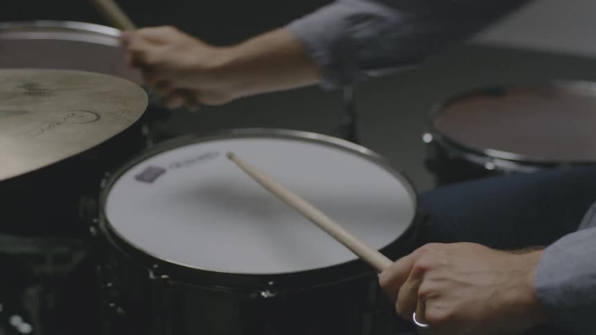 A man plays drums