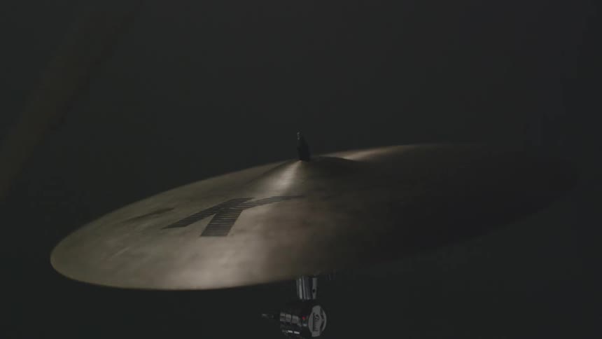 A drummer hits a cymbal with a drumstick