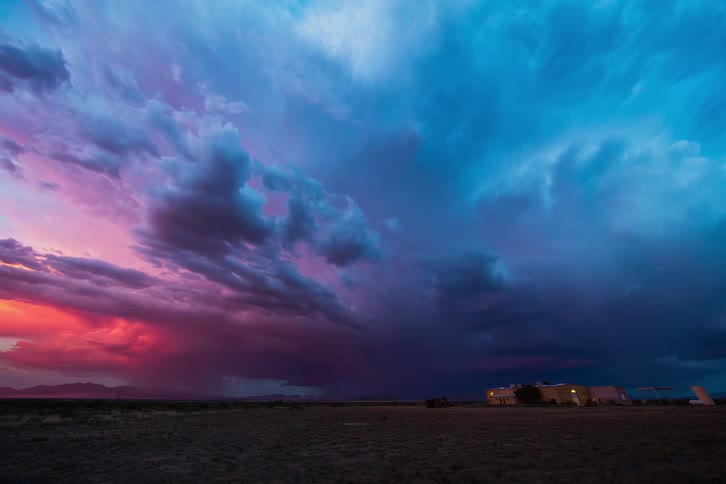 Storm clouds darken and lightning flashes