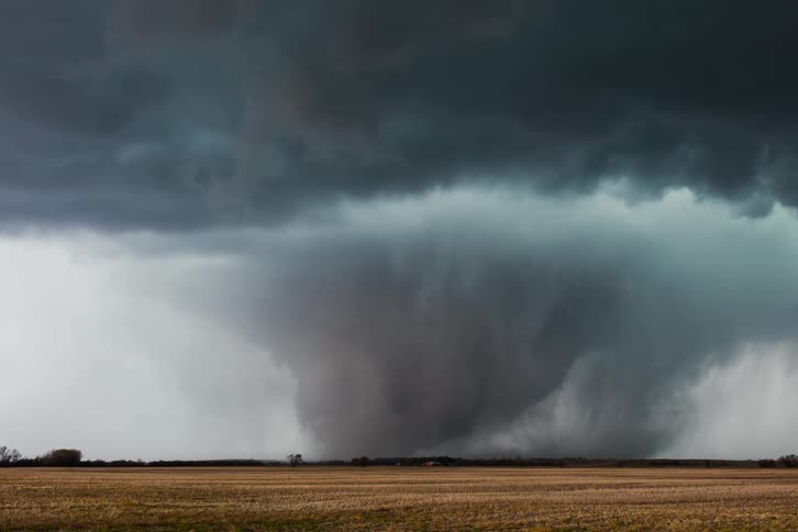 The tornado spins and moves pouring rain behind