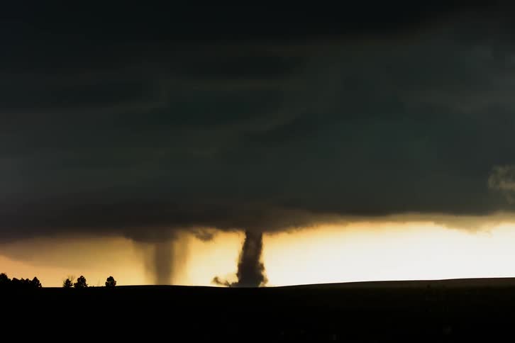 Dual tornadoes developing and moving across the plains in a time-lapse