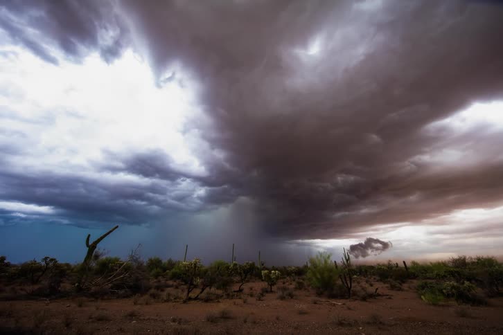 Storm clouds gather and darken over the desert