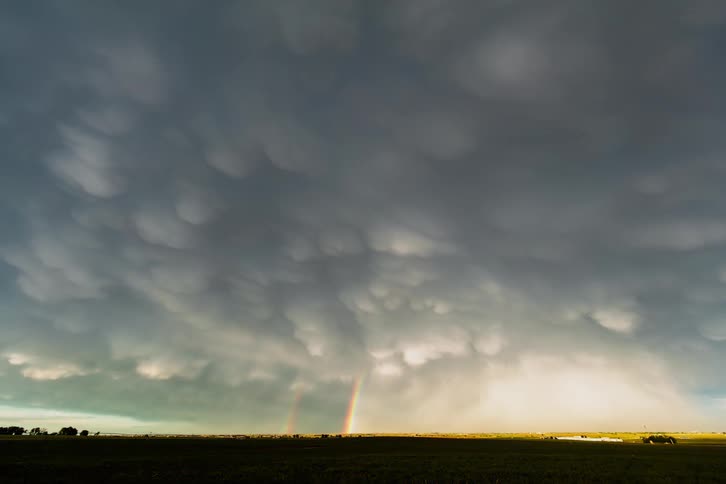 Time-lapse of major storm arriving near sunset with two rainbows present