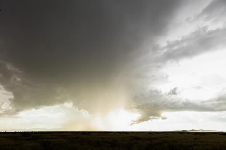 The rain clouds are pouring in the distance