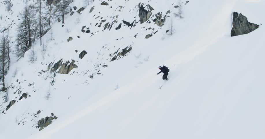 A person jumps off a cliff on skis