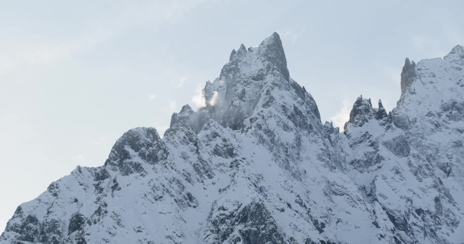 Reveal Snow covered mountains on a cloudy day