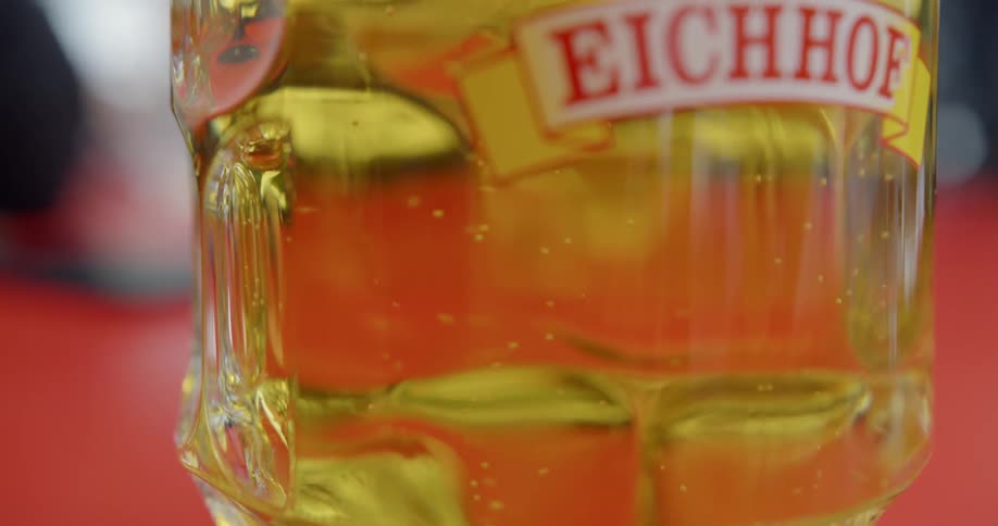Bubbles are ascending in a glass of beer in daylight