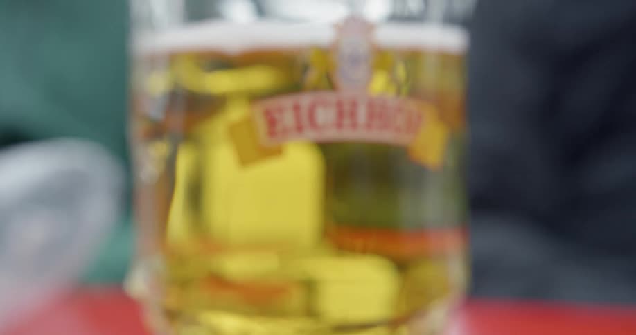A glass of beer sits on a table rack focus
