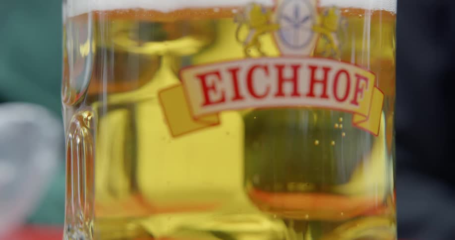 Beer foam rises to the top in a glass jar