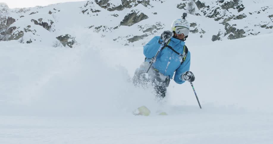 A skier skis through the snow