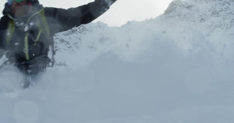 A snowboarder jumps in the snow