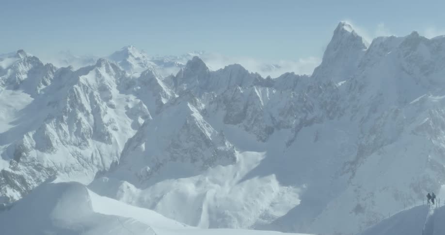People walk up a snow covered mountain