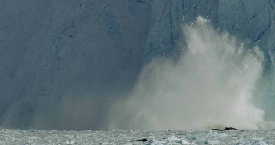 Ice slides off a glacier into the water