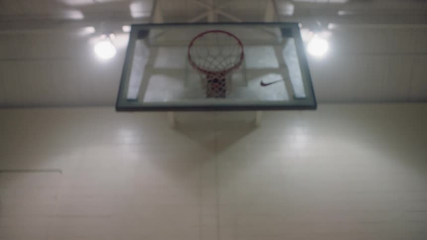 Child jumps by a basketball hoop