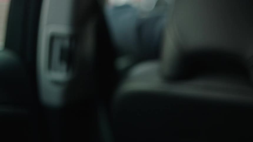 Cinematic close-up of hands lifting a smartphone with a black screen inside a car during daylight. The blank display allows for easy screen replacement, ideal for VFX, app mockups, compositing, and digital lifestyle or technology projects.