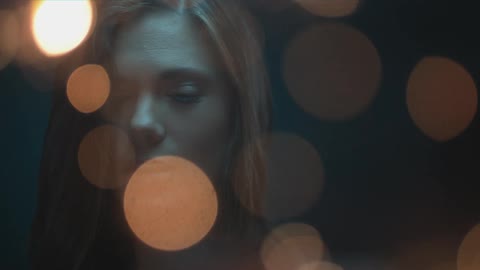Lights flash in front of a woman's face
