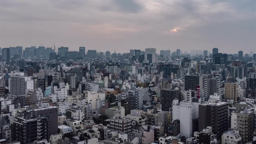 Clouds roll over a large city during the day