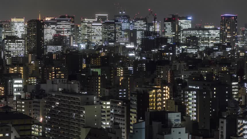 The lights on all the tall buildings flicker at night