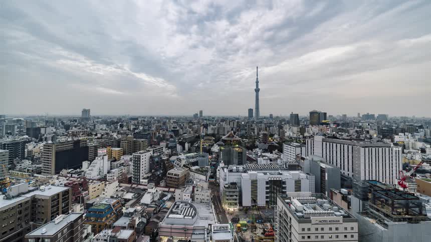 Clouds roll over a large city during the day